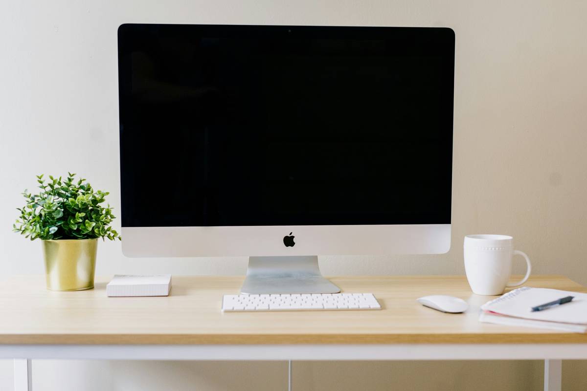 Tech gadgets for computer including portable monitor and USB-C hub on desk