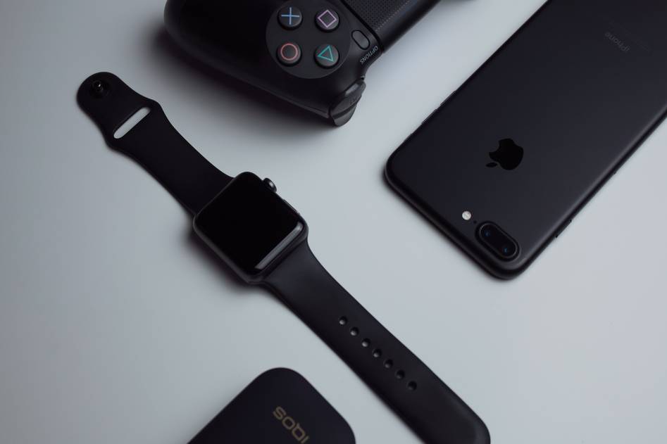 Modern tech gadgets arranged on desk with review notes