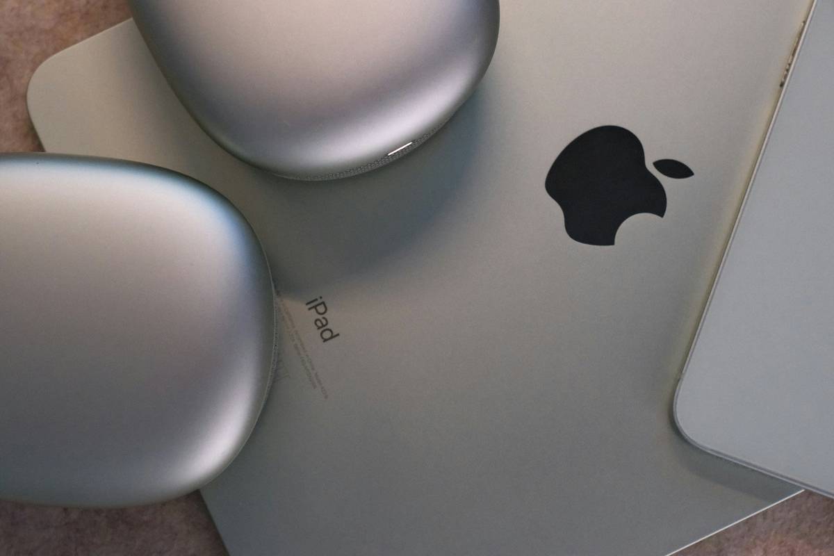 tech gadgets for college students including laptop, wireless earbuds, portable SSD, and ergonomic keyboard on a study desk